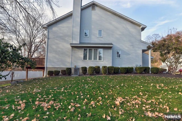 rear view of house featuring a yard