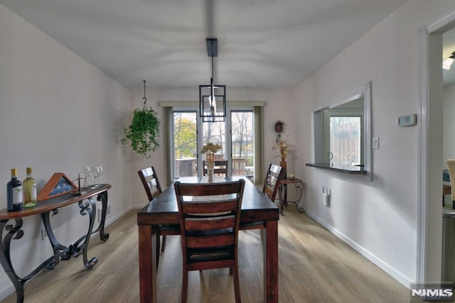 dining space featuring light wood-type flooring