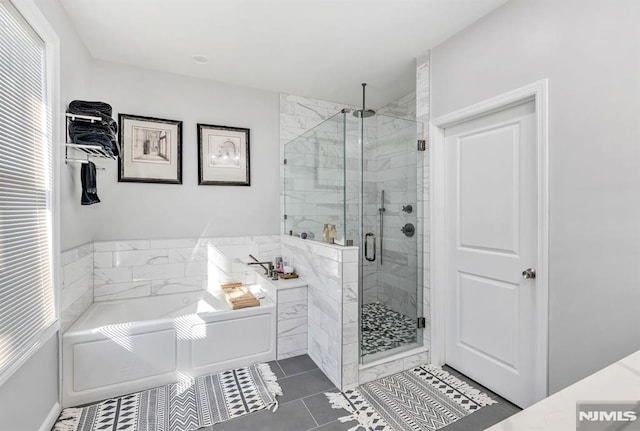 bathroom featuring tile patterned floors and separate shower and tub