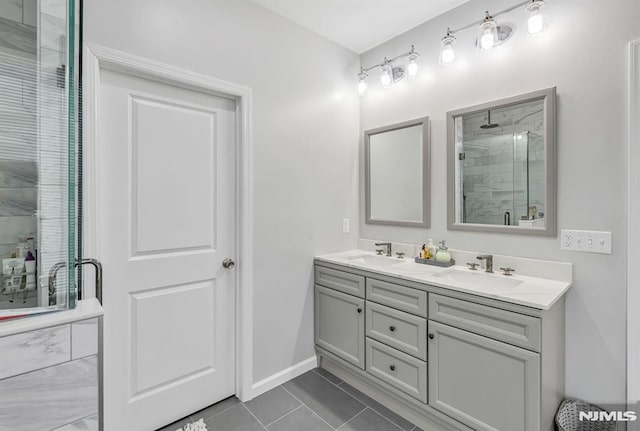 bathroom featuring tile patterned flooring, vanity, and a shower with shower door