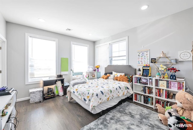 bedroom with dark hardwood / wood-style flooring