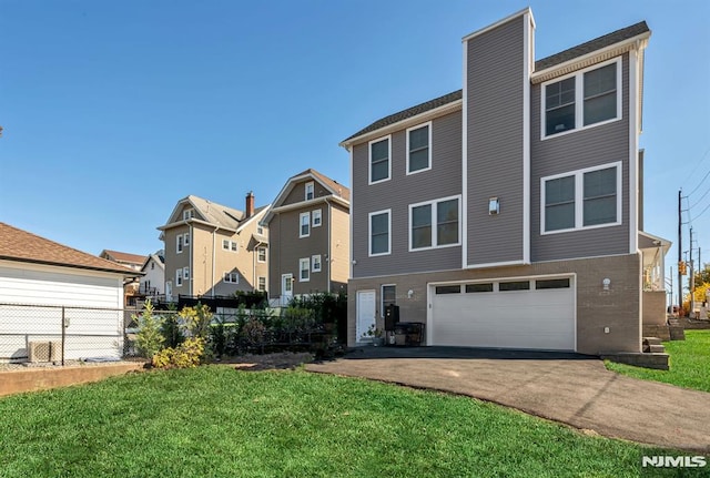 view of front of property with a front yard and a garage