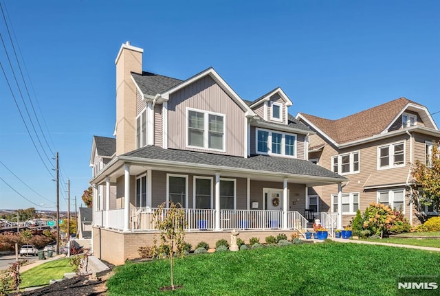 view of front of property with a porch and a front yard