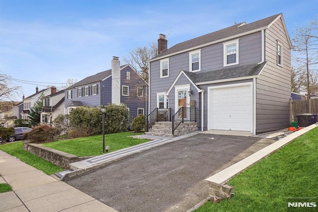 view of front facade featuring a front yard and a garage