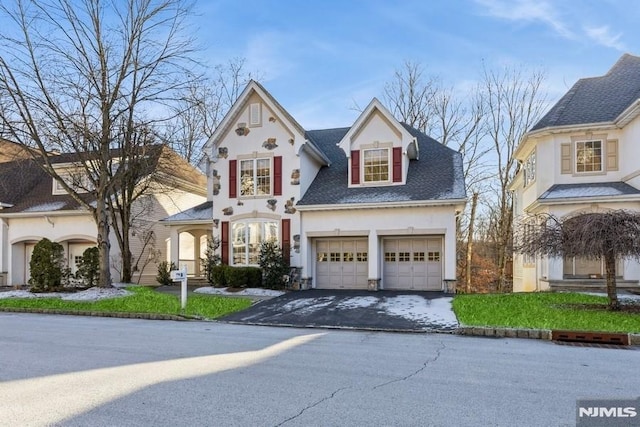 view of front of property featuring a front yard and a garage