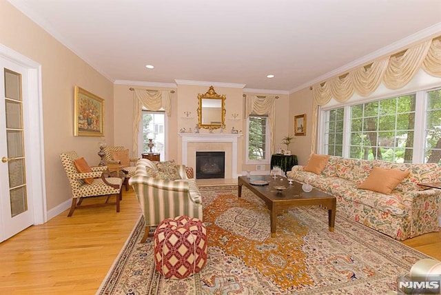 living room featuring ornamental molding and light hardwood / wood-style floors