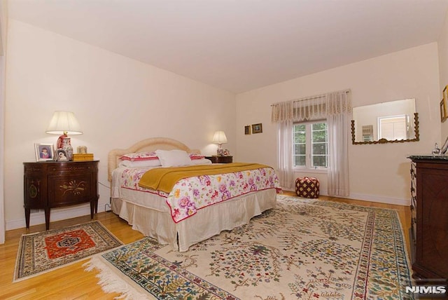 bedroom with hardwood / wood-style flooring