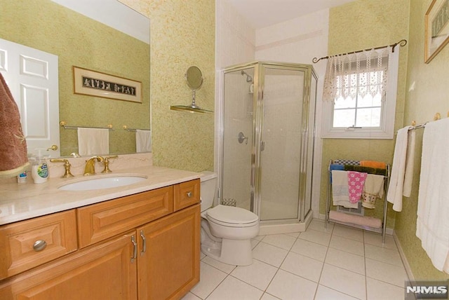 bathroom featuring toilet, an enclosed shower, tile patterned floors, and vanity