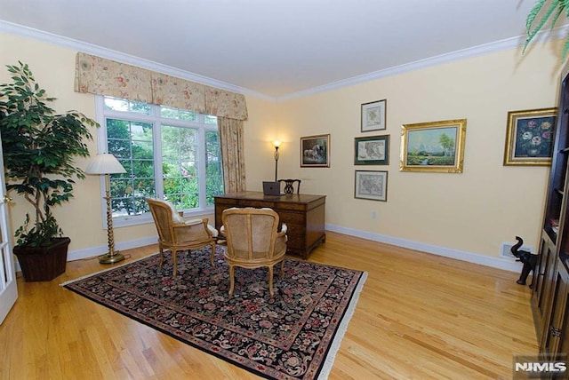 office space with ornamental molding and light hardwood / wood-style floors