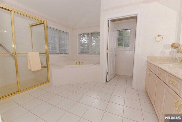 bathroom featuring independent shower and bath, vanity, and tile patterned floors