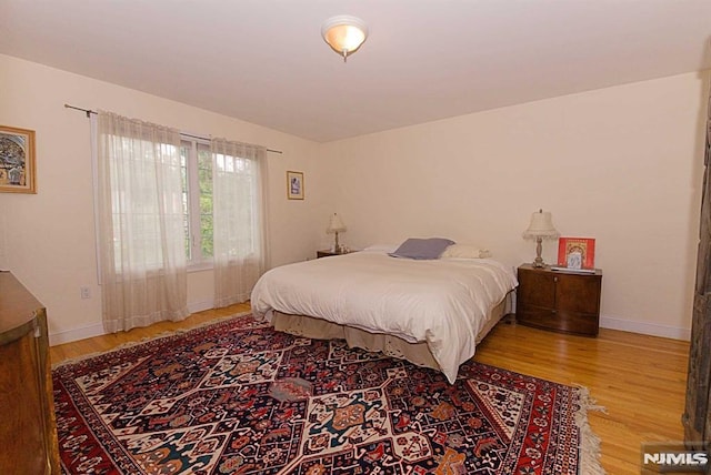 bedroom with wood-type flooring