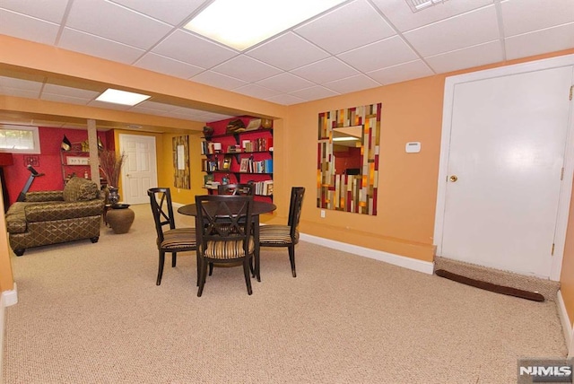 dining room with carpet flooring and a drop ceiling