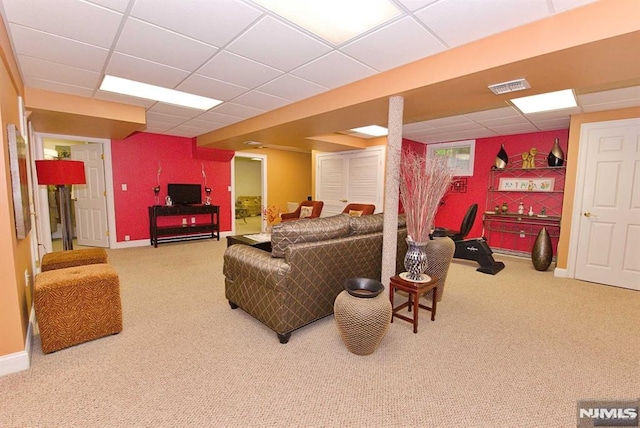 carpeted living room with a paneled ceiling