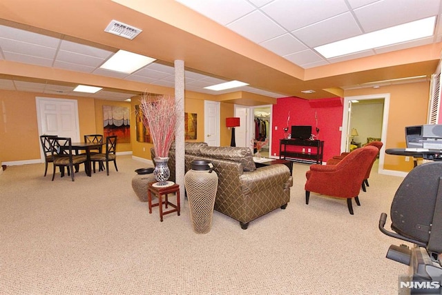 carpeted living room with a drop ceiling