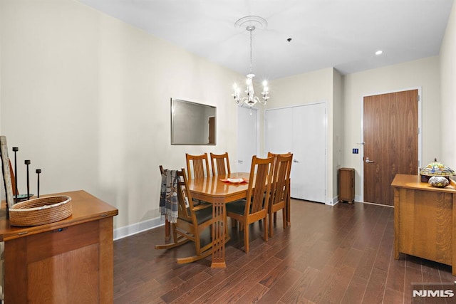 dining space featuring an inviting chandelier and dark hardwood / wood-style floors