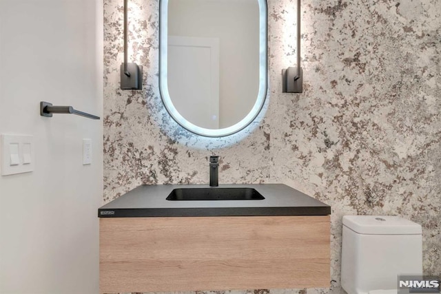 bathroom with vanity and toilet