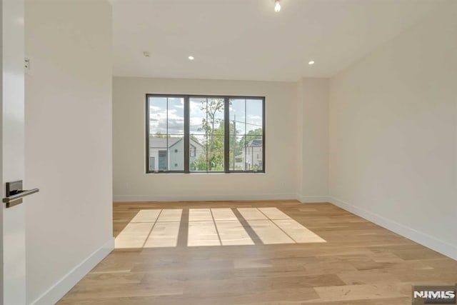 spare room featuring light hardwood / wood-style floors