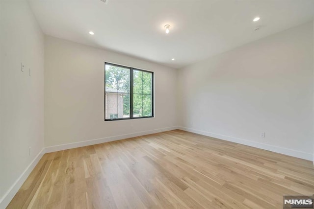 spare room with light hardwood / wood-style flooring