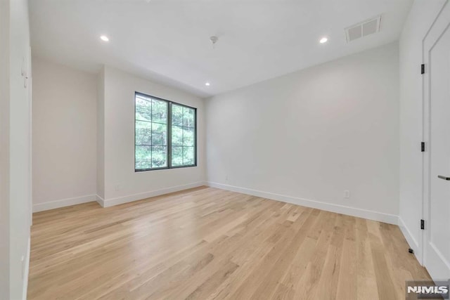 unfurnished room with light wood-type flooring