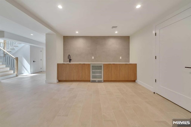 interior space with wine cooler and sink