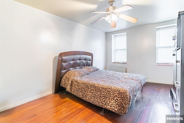 bedroom featuring wood-type flooring and ceiling fan