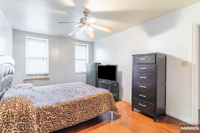 bedroom with ceiling fan and light hardwood / wood-style flooring