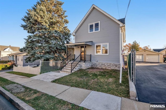 front of property featuring a garage and an outdoor structure