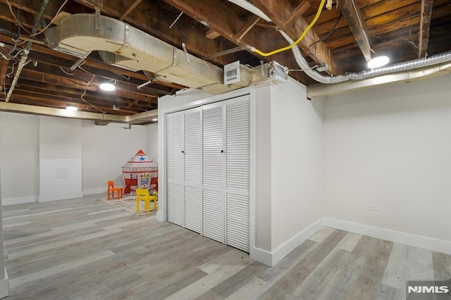 basement featuring hardwood / wood-style flooring