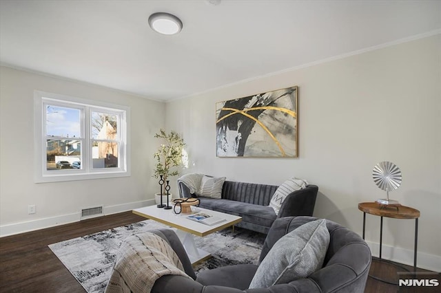 living room with dark hardwood / wood-style flooring and crown molding