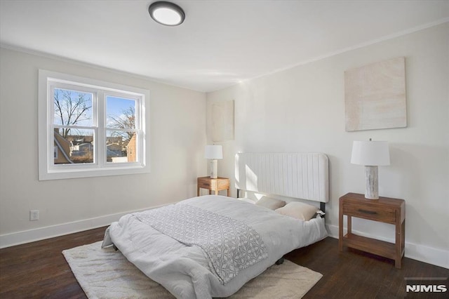 bedroom with dark hardwood / wood-style flooring