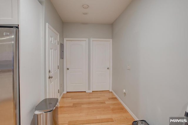 corridor with light wood-type flooring