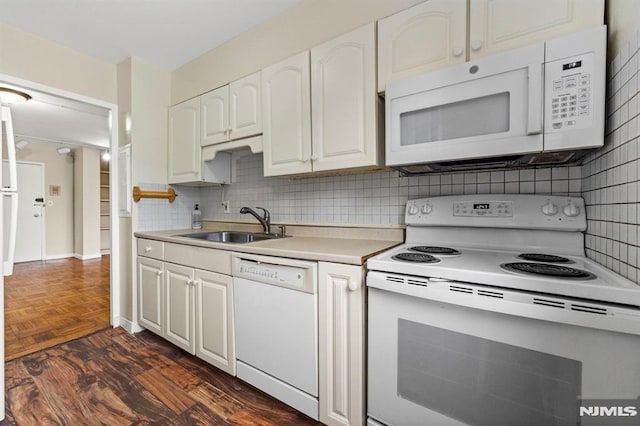 kitchen with decorative backsplash, sink, white cabinets, and white appliances