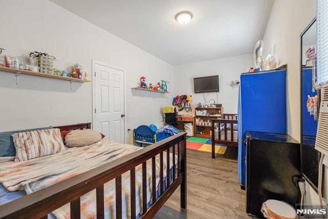 bedroom with hardwood / wood-style floors