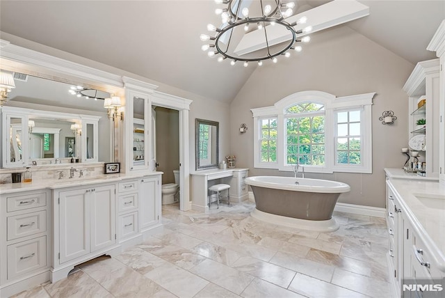 bathroom featuring vanity, toilet, a tub to relax in, and high vaulted ceiling