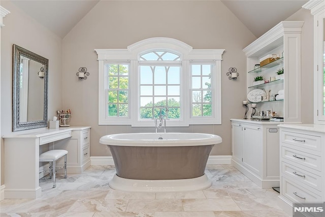 bathroom with a tub and vaulted ceiling