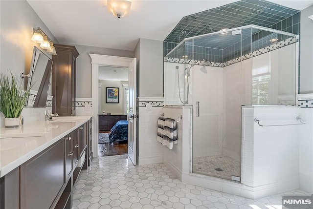 bathroom featuring tile patterned flooring, vanity, and walk in shower