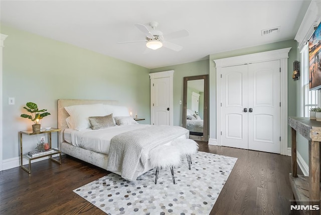 bedroom featuring a closet, dark hardwood / wood-style floors, and ceiling fan