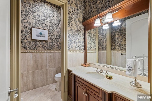 bathroom with tile patterned floors, toilet, and vanity