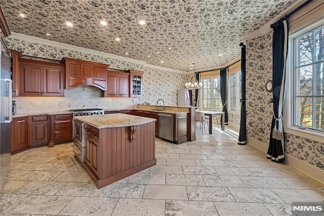 kitchen with a center island, a breakfast bar, decorative backsplash, sink, and stainless steel appliances