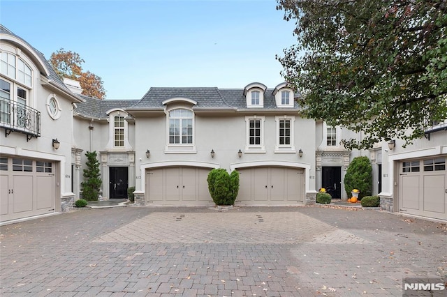 french country inspired facade with a garage