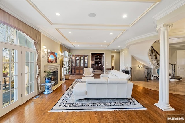 living room with ornamental molding, hardwood / wood-style flooring, coffered ceiling, and decorative columns