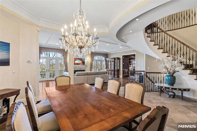 dining space featuring plenty of natural light, ornamental molding, and french doors