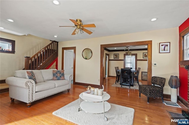 living room with ceiling fan and hardwood / wood-style floors