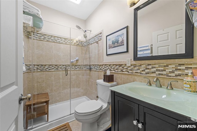 bathroom with vanity, toilet, and an enclosed shower