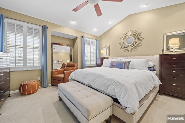 bedroom with ceiling fan, light carpet, and vaulted ceiling