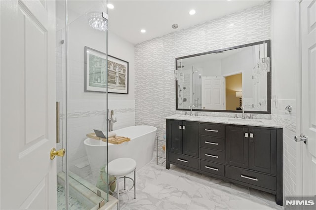 bathroom featuring shower with separate bathtub, vanity, and tile walls