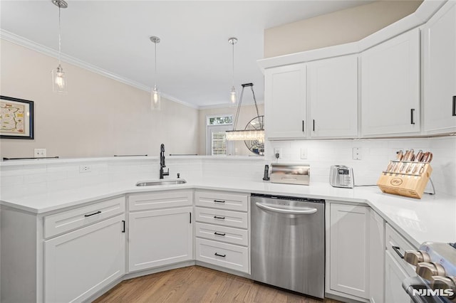 kitchen with light wood-type flooring, white cabinets, sink, decorative light fixtures, and dishwasher