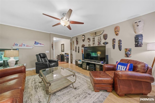 living room featuring hardwood / wood-style floors, ceiling fan, and crown molding