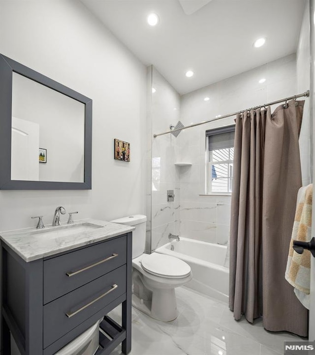 full bathroom featuring toilet, vanity, and shower / tub combo with curtain