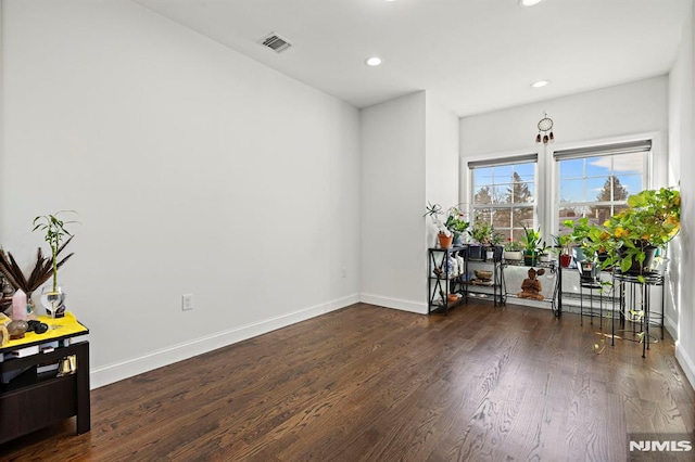 unfurnished room with dark wood-type flooring